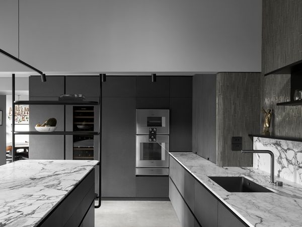 Gaggenau appliances installed in a luxury dark kitchen with island worktop