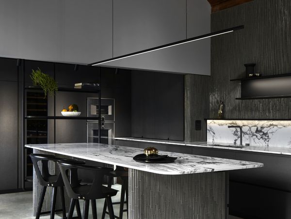 Gaggenau appliances installed in a luxury dark kitchen with island worktop