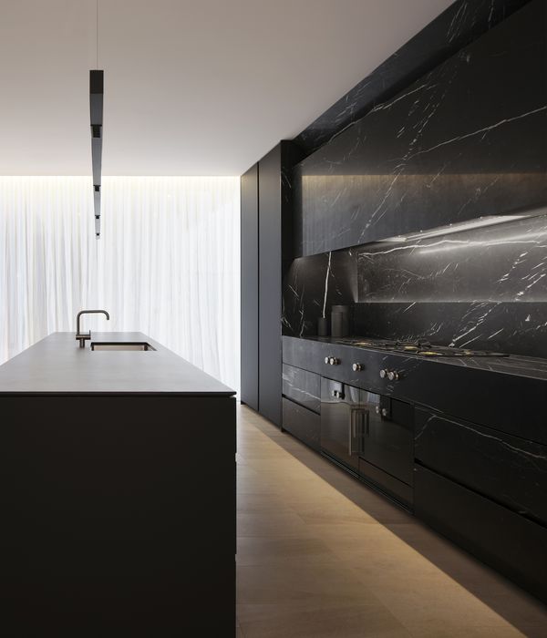 Gaggenau appliances installed in a luxury dark kitchen with island worktop