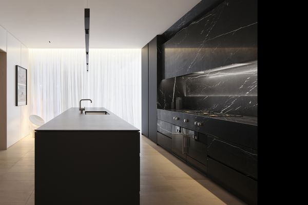 Gaggenau appliances installed in a luxury dark kitchen with island worktop