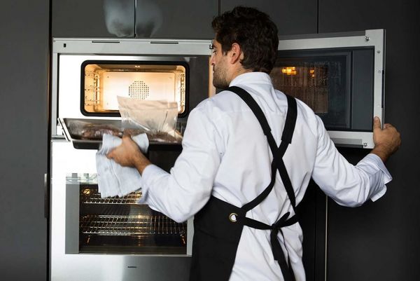 Chef Romuald Oudeyer opening a Gaggenau combo-steam oven