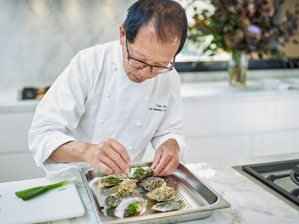 Close up of chef Tony Tan preparing seafood