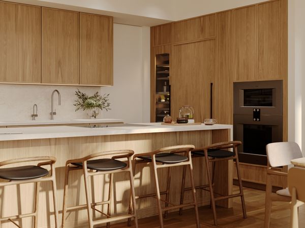 A view of a kitchen and living space in the Ālia 888 Ala Moana development featuring Gaggenau appliances.