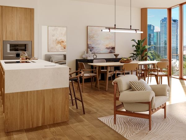 A view of a kitchen and living space in The Ālia 888 Ala Moana development featuring Gaggenau appliances.