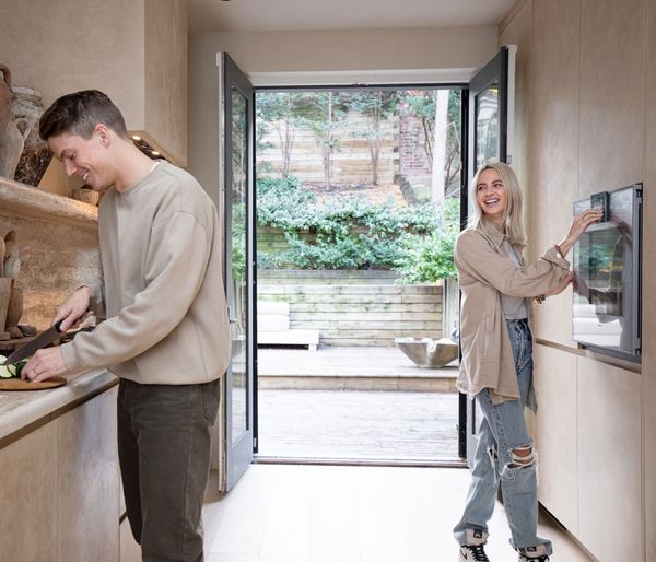 Montana Labelle and her brother cooking together, smiling and laughing. 