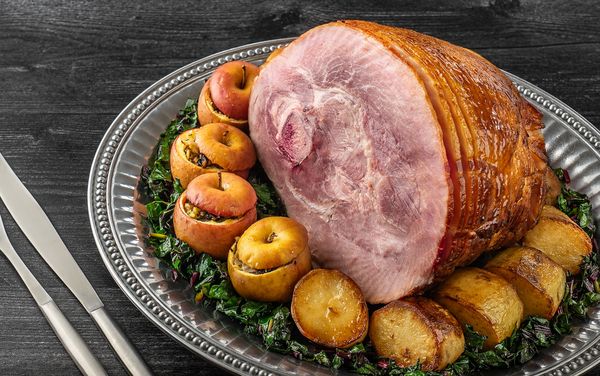 Close-up of a Baked Ham with Apple Cider Maple Glaze on an ornate platter 