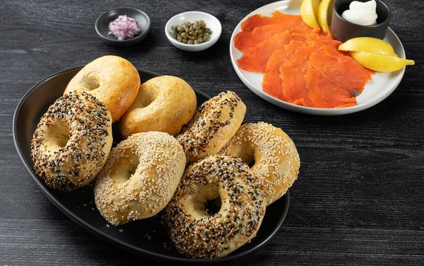 Close-up image of various types of bagels, surrounded by a variety of fillings