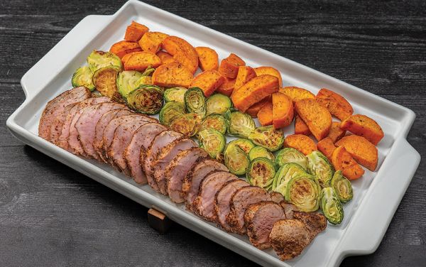 Close-up image of a dish containing Spice Rubbed Pork Tenderloin and Crisp Sweet Potato Wedges