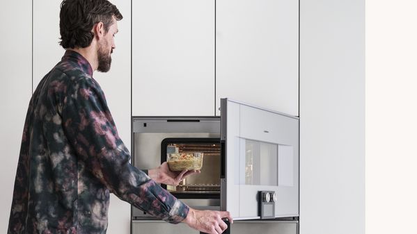 Gaggenau owner opening his appliance to warm up food