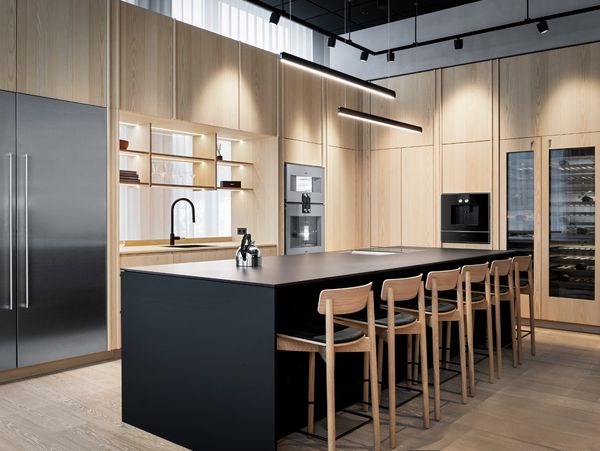 Gaggenau Oslo showroom displaying a luxury kitchen designed in light wood and stainless steel appliances