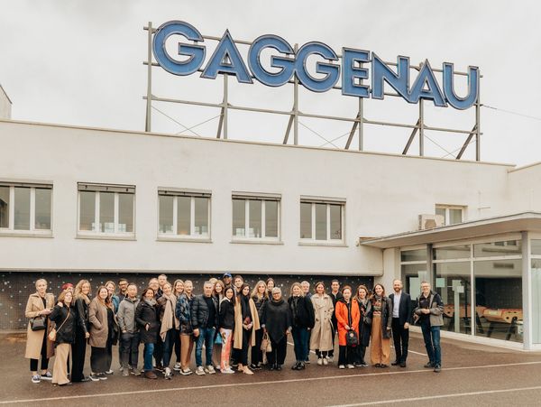 A group shot in front of the Gaggenau factory, with its iconic blue enamel sign. 