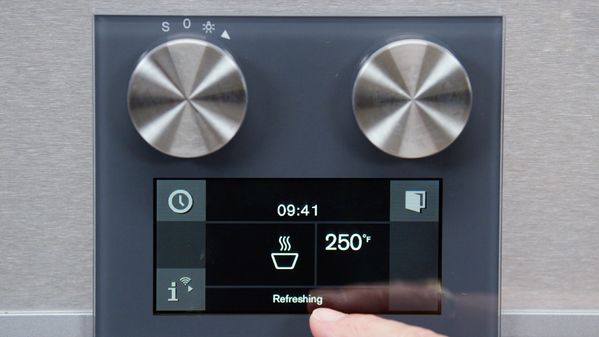 A close-up image of a Gaggenau combi steam oven TFT with the user selecting the refreshing mode