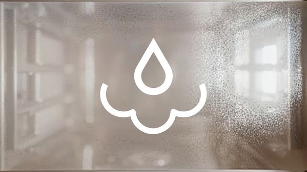 A Gaggenau combi steam oven window covered in condensation with a steam removal symbol superimposed over it 