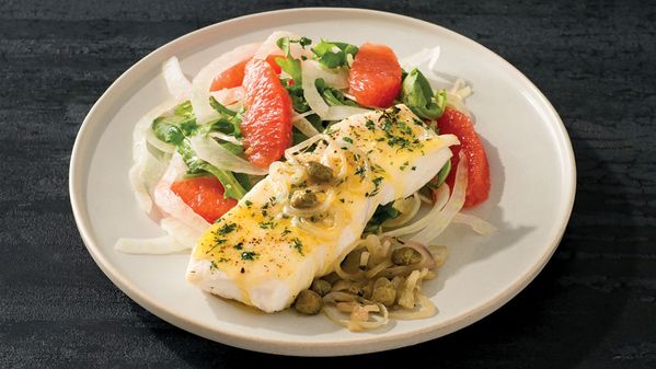 A white dish containing Baked Halibut with Capers and Citrus Fennel Salad