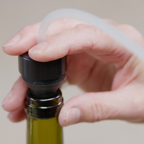 Close-up of a wine bottle being sealed with the Gaggenau bottle adapter and vacuum drawer