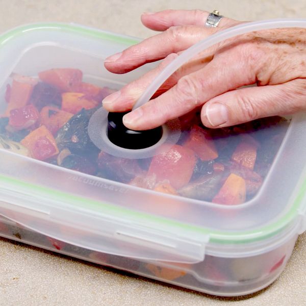 Close-up of a vacuuming container being sealed with the Gaggenau adapter and vacuum drawer