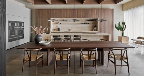 The Houston showroom's main kitchen, featuring gorgeous earth tones and a large wooden dining table that welcomes guests. 