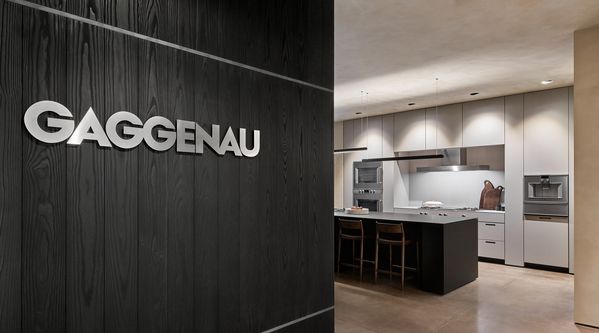 The Gaggenau logo in brushed steel lettering, welcoming guests into the showroom. 