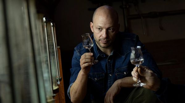 Elías Lopez Montero of Bodegas Verum wine looks closely at a tasting glass. 