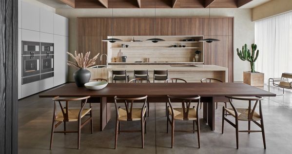 The Houston showroom's main kitchen, featuring gorgeous earth tones and a large wooden dining table that welcomes guests.