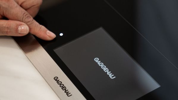 A close-up of Tammy using her Gaggenau induction cooktop