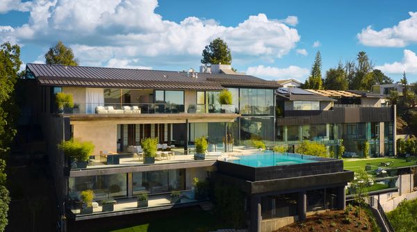 The Bel Air home in the daylight against a bright blue Los Angeles sky. 