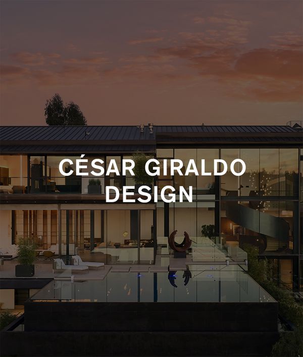 Exterior of César Giraldo's stunning Bel Air project at sunset, with the home's glass exterior mirrored in the infinity pool below.