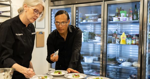 Chefs Bobby Cortez and Amy Alcorn put the final touches on a dish together. 