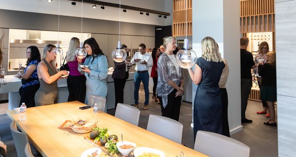 Guests exploring the showroom space and chatting. 