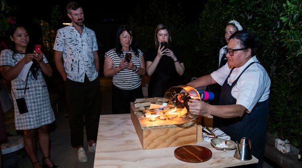 Chef Minh demonstrates her "Good Fire" dish for intrigued guests. 