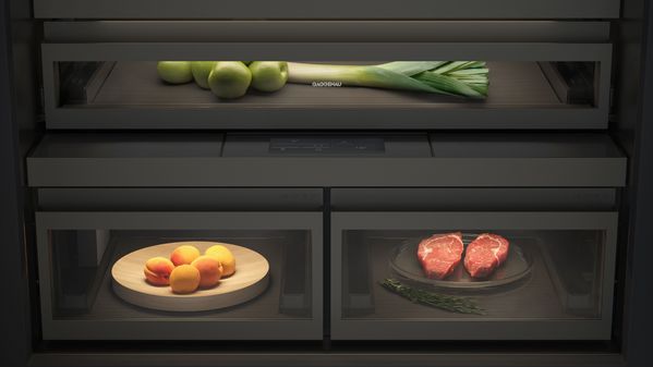 View inside the new Gaggenau LUX cooling appliance showing the glare-free illumination and dark brushed stainless interior