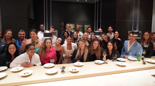 Guests pose and smile at Gaggenau's Miami showroom.