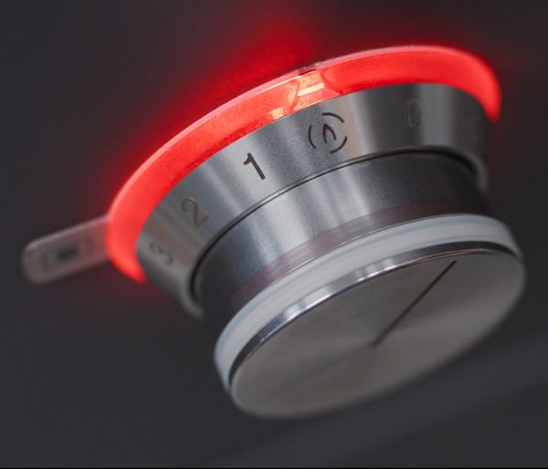 The illuminated control knob of a Gaggenau 5 Burner Vario Gas Cooktop set to its simmer function