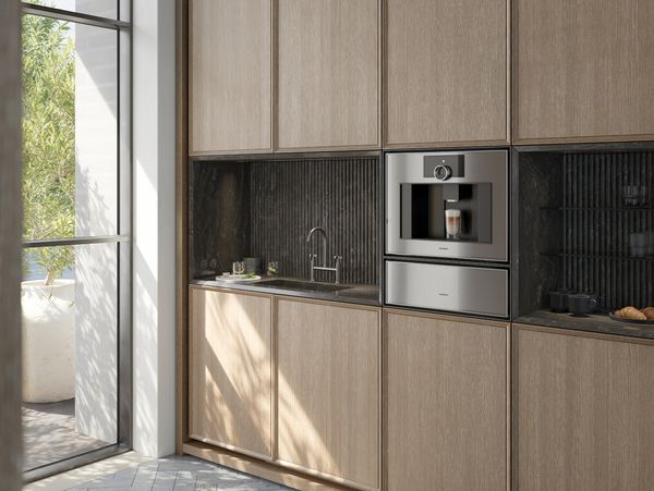 The Gaggenau Expressive series fully automatic espresso machine installed between other complimentary series appliances