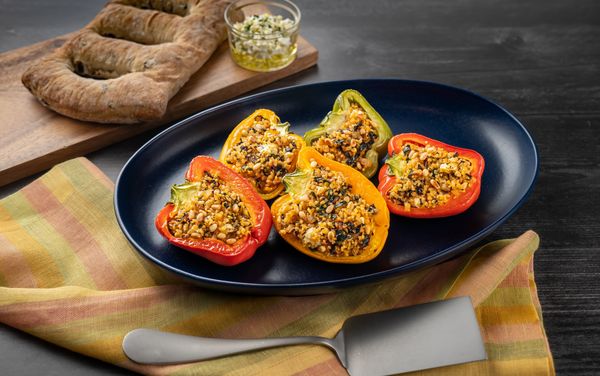 A plate containing Baked Peppers with Bulgur, Chard and Feta Cheese 