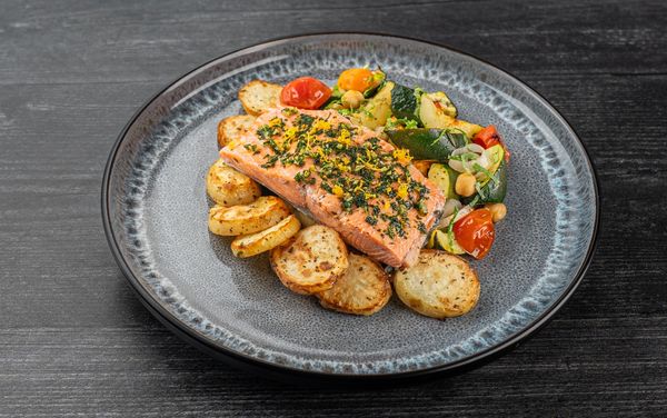 A plate containing Sockeye Salmon with Roasted Zucchini, Chickpeas and Tomatoes 