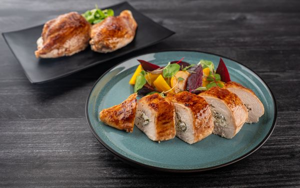 A plate containing Herb and Goat Cheese Stuffed Chicken Breasts with Roasted Beet Salad 