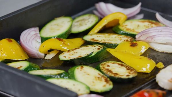 Close-up image of vegetables cooking in the Gaggenau griddle pan 