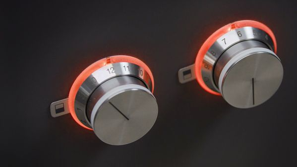 Close-up image of two illuminated Gaggenau Vario grill control knobs 