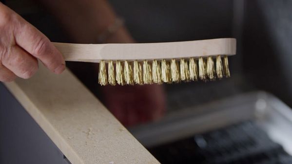 Close-up image of a Gaggenau wire brush for cleaning the various electric grill 