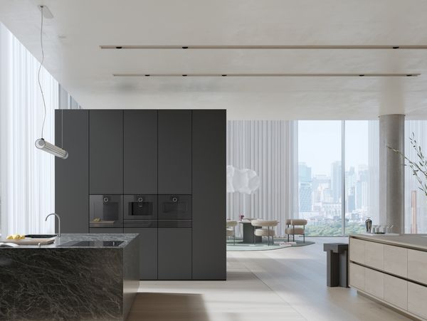 View into an open plan luxury kitchen fitted with Gaggenau Minimalist series appliances