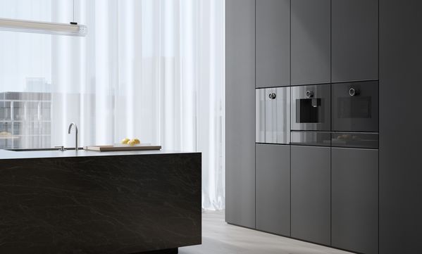 View into an open plan luxury kitchen fitted with Gaggenau Minimalistic series appliances.