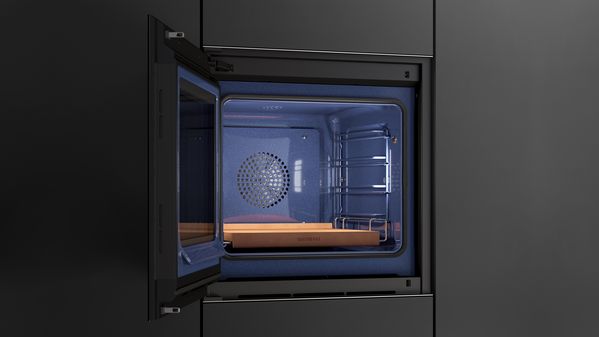 A Gaggenau Minimalistic series oven with its door open, showing the blue interior and a Gaggenau baking stone