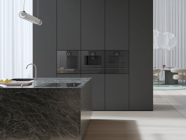 View into an open plan luxury kitchen fitted with Gaggenau Minimalistic series appliances