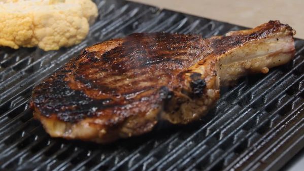 A close-up of food being cooked on a Gaggenau electric grill