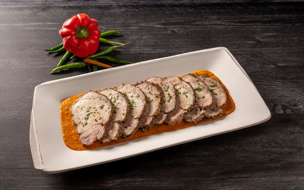 A dish containing Slow Roast Pork Loin with Piri Piri Sauce