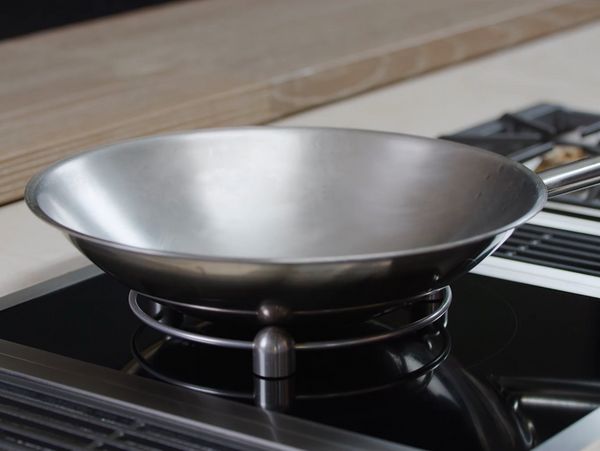 Close-up of a Gaggenau 400 series Vario induction cooktop, wok ring and wok pan
