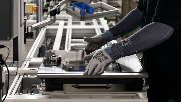 Gaggenau worker adjusting an expressive oven door on the assembly line in Lipsheim