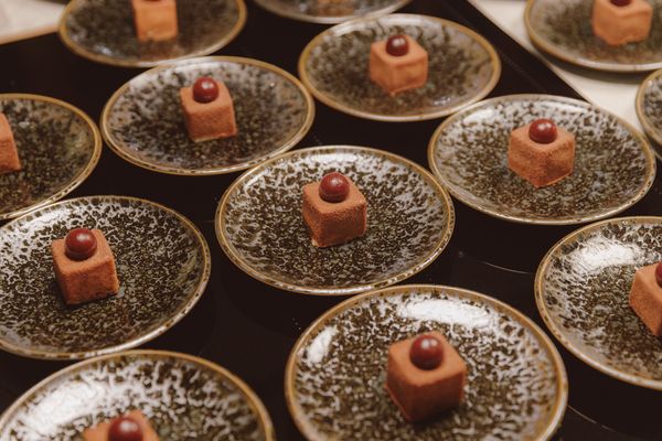 Chocolate desserts on patterned plates on a Gaggenau induction cooktop.