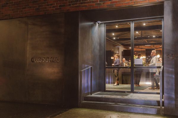 An exterior shot of the Gaggenau showroom at night, featuring warm lighting and a welcoming atmosphere.